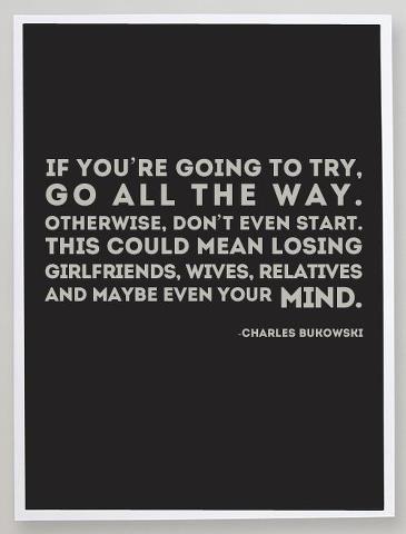 Dark gray poster with a white border and light gray capital letters reading: "If you're going to try, go all the way. Otherwise, don't even start. This could mean losing girlfriends, wives, relatives and maybe even your mind." Smaller text at the bottom right reads: "-Charles Bukowski".