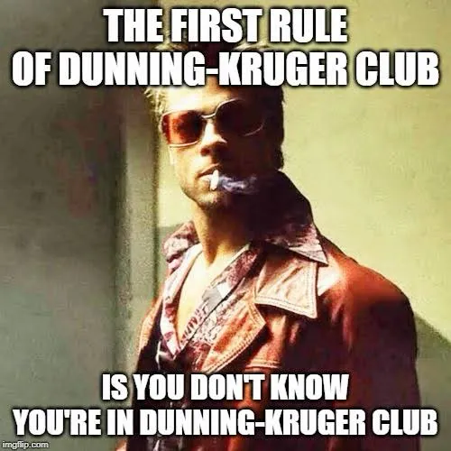 A man with slicked blond hair, tinted orange sunglasses and a cigarette in his mouth wears a red leather coat over a patterned shirt. Top text: "THE FIRST RULE OF DUNNING-KRUGER CLUB". Bottom text: "IS YOU DON'T KNOW YOU'RE IN DUNNING-KRUGER CLUB".