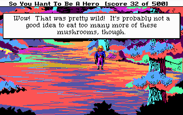 Screenshot from an EGA computer game with a title bar reading "So You Want To Be A Hero [score 32 of 500]". A blond hero in a purple cape stands on a forest path in psychedelic pink, orange, blue and teal. A text box reads: "Wow! That was pretty wild! It's probably not a good idea to eat too many more of these mushrooms, though."