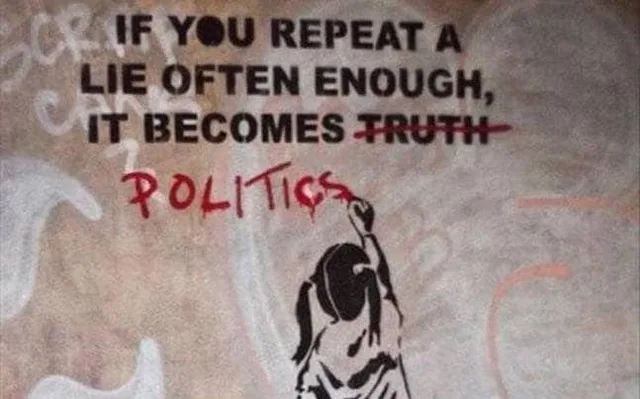 Stencil street art on a weathered wall. Black text reads "IF YOU REPEAT A LIE OFTEN ENOUGH, IT BECOMES TRUTH" with "TRUTH" struck through in red. Below it, red handwritten "POLITICS" is painted by a stenciled girl reaching up with a paintbrush.