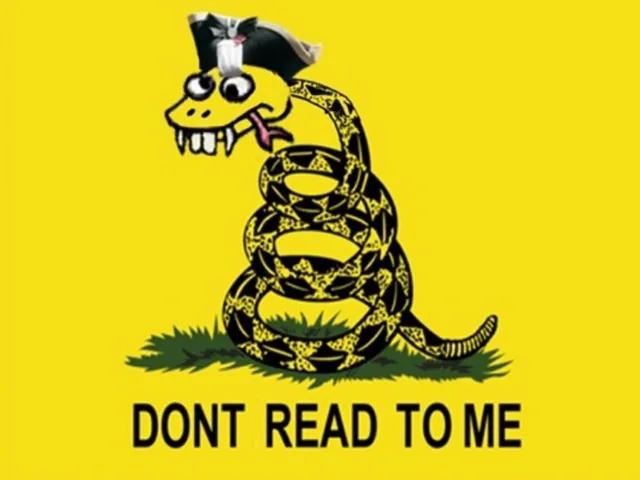 A parody of the Gadsden flag on a yellow background: a coiled rattlesnake on a patch of grass with a cartoonish, goofy face, googly eyes, buck teeth, and a pirate-style tricorn hat. Black text beneath reads: "DONT READ TO ME".
