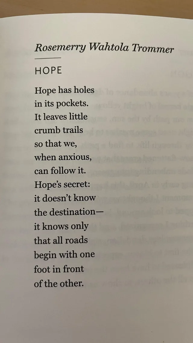 Photo of a book page with a poem. Italic header: "Rosemerry Wahtola Trommer". Title: "HOPE". Poem: "Hope has holes in its pockets. It leaves little crumb trails so that we, when anxious, can follow it. Hope's secret: it doesn't know the destination—it knows only that all roads begin with one foot in front of the other."