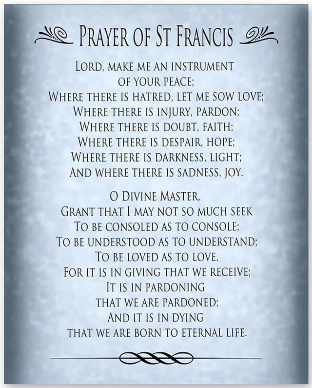 A framed-style poster with a mottled light blue parchment background and dark vignette edges, headed "PRAYER OF ST FRANCIS" between two decorative flourishes. Text: "Lord, make me an instrument of your peace; Where there is hatred, let me sow love; Where there is injury, pardon; Where there is doubt, faith; Where there is despair, hope; Where there is darkness, light; And where there is sadness, joy. O Divine…