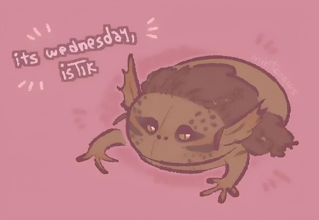 Digital drawing of a chubby brown frog-like creature with pointed ears, a dark brown hair-like mane, speckled cheeks and small orange eyes, crouching on a pink background. Handwritten text at upper left reads: "its wednesday, istik". Faint watermark: "mintcrows".
